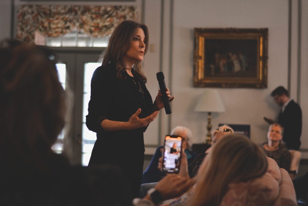 A woman giving a speech to a group of people.