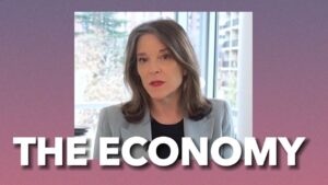 A woman in a suit with the words rigged economy issues.